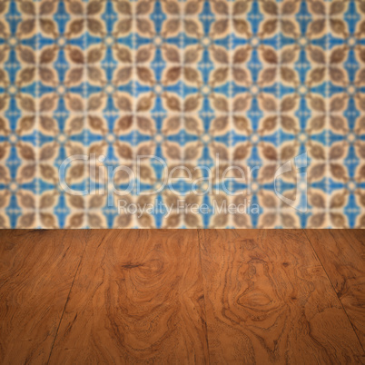 Wood table top and blur vintage ceramic tile pattern wall