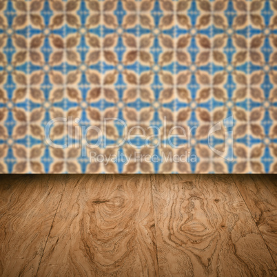 Wood table top and blur vintage ceramic tile pattern wall