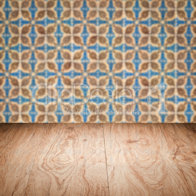 Wood table top and blur vintage ceramic tile pattern wall