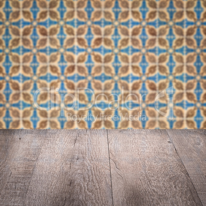 Wood table top and blur vintage ceramic tile pattern wall