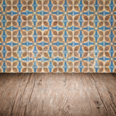 Wood table top and blur vintage ceramic tile pattern wall