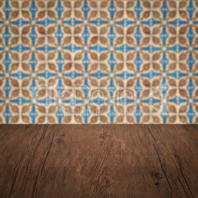 Wood table top and blur vintage ceramic tile pattern wall