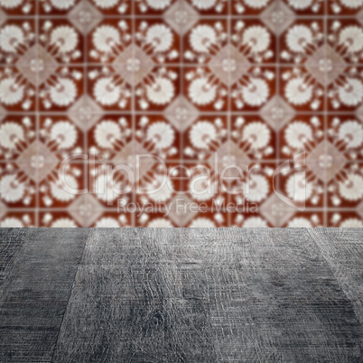 Wood table top and blur vintage ceramic tile pattern wall