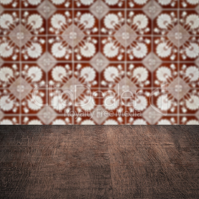 Wood table top and blur vintage ceramic tile pattern wall