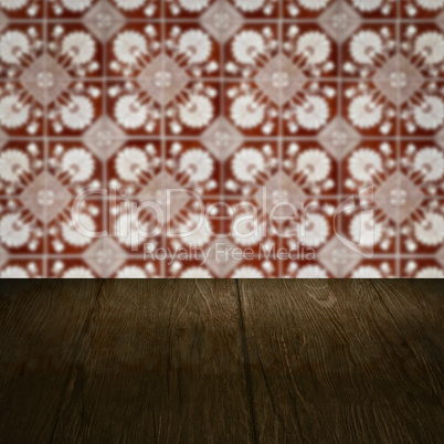 Wood table top and blur vintage ceramic tile pattern wall