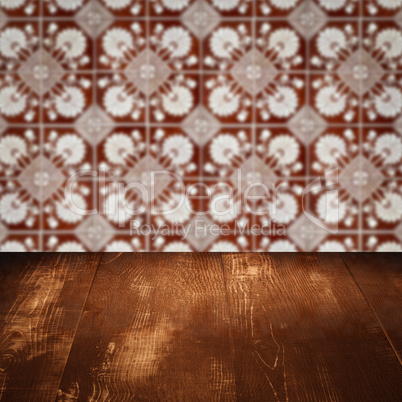 Wood table top and blur vintage ceramic tile pattern wall