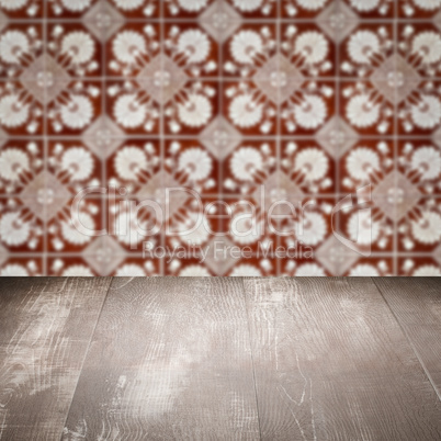 Wood table top and blur vintage ceramic tile pattern wall