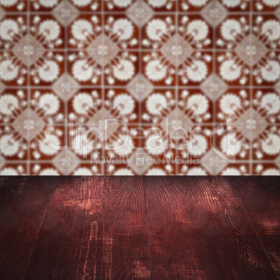 Wood table top and blur vintage ceramic tile pattern wall