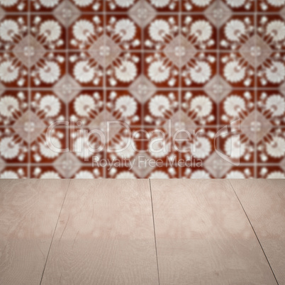 Wood table top and blur vintage ceramic tile pattern wall