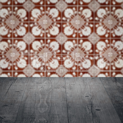 Wood table top and blur vintage ceramic tile pattern wall