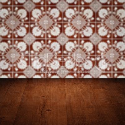 Wood table top and blur vintage ceramic tile pattern wall