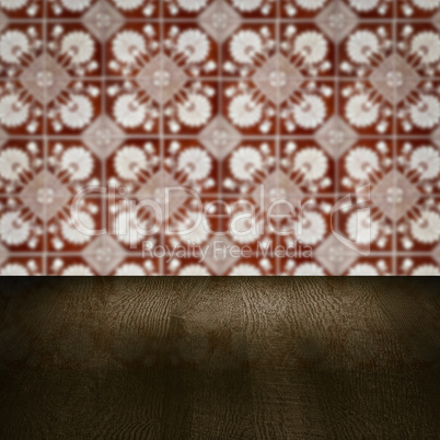 Wood table top and blur vintage ceramic tile pattern wall