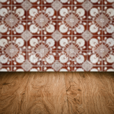 Wood table top and blur vintage ceramic tile pattern wall