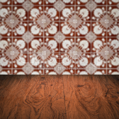 Wood table top and blur vintage ceramic tile pattern wall