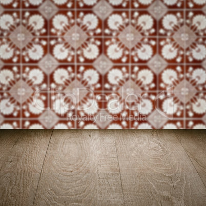 Wood table top and blur vintage ceramic tile pattern wall