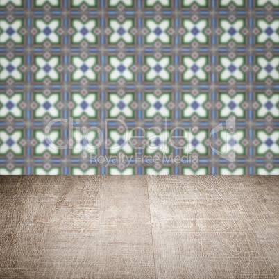 Wood table top and blur vintage ceramic tile pattern wall