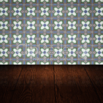 Wood table top and blur vintage ceramic tile pattern wall