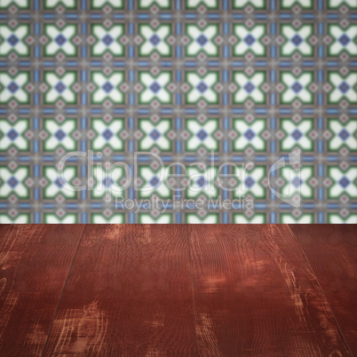 Wood table top and blur vintage ceramic tile pattern wall