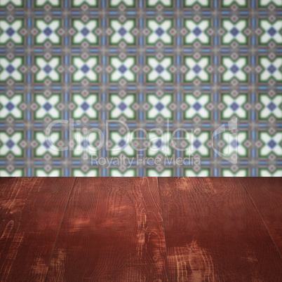 Wood table top and blur vintage ceramic tile pattern wall