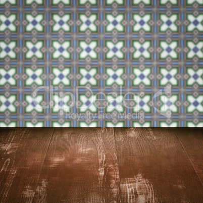 Wood table top and blur vintage ceramic tile pattern wall