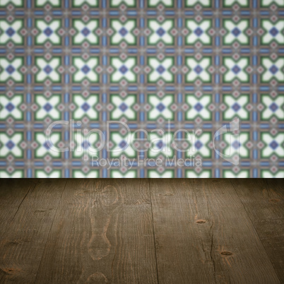 Wood table top and blur vintage ceramic tile pattern wall