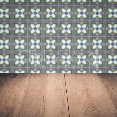 Wood table top and blur vintage ceramic tile pattern wall