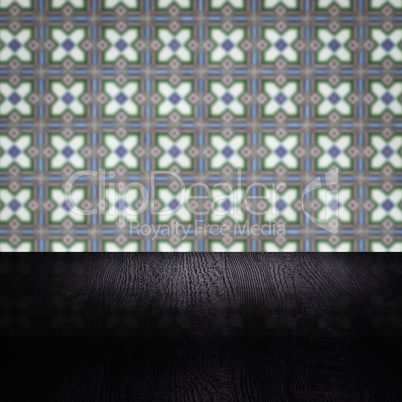 Wood table top and blur vintage ceramic tile pattern wall