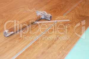 hammer and laminate plank on floor