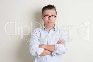 Portrait of mature Asian male people arms crossed