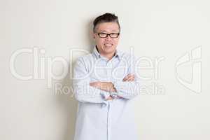 Portrait of mature Asian man arms crossed