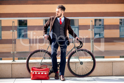 Handsome businessman and his bicycle