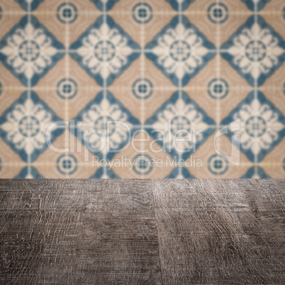 Wood table top and blur vintage ceramic tile pattern wall