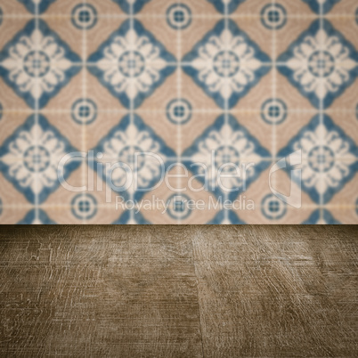 Wood table top and blur vintage ceramic tile pattern wall