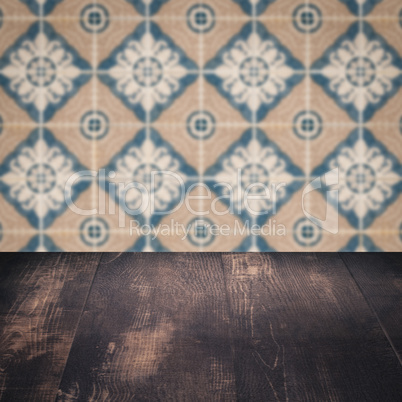 Wood table top and blur vintage ceramic tile pattern wall