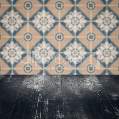 Wood table top and blur vintage ceramic tile pattern wall