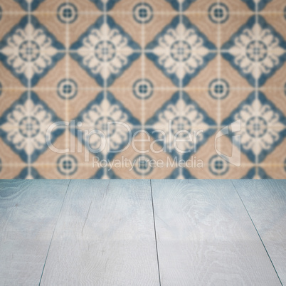 Wood table top and blur vintage ceramic tile pattern wall