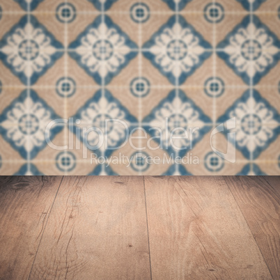 Wood table top and blur vintage ceramic tile pattern wall Wood table top and blur vintage ceramic tile pattern wall