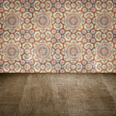 Wood table top and blur vintage ceramic tile pattern wall
