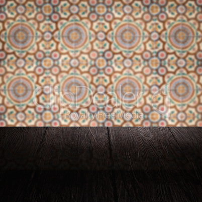Wood table top and blur vintage ceramic tile pattern wall Wood table top and blur vintage ceramic tile pattern wall