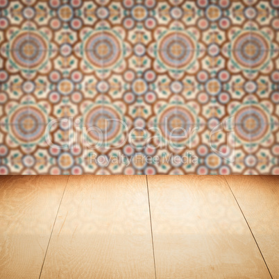 Wood table top and blur vintage ceramic tile pattern wall