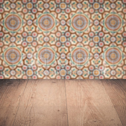 Wood table top and blur vintage ceramic tile pattern wall