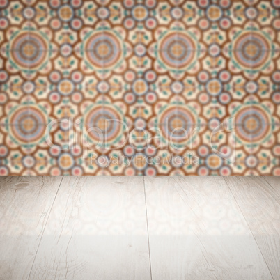 Wood table top and blur vintage ceramic tile pattern wall