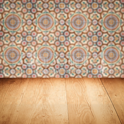 Wood table top and blur vintage ceramic tile pattern wall