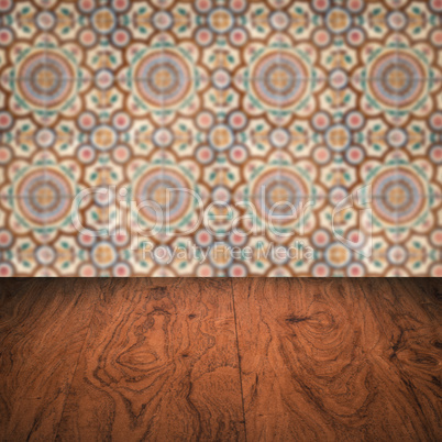 Wood table top and blur vintage ceramic tile pattern wall