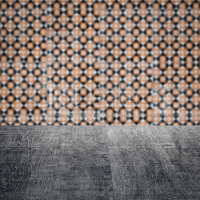 Wood table top and blur vintage ceramic tile pattern wall