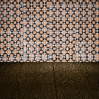 Wood table top and blur vintage ceramic tile pattern wall