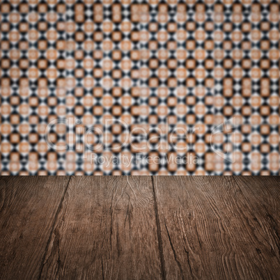 Wood table top and blur vintage ceramic tile pattern wall