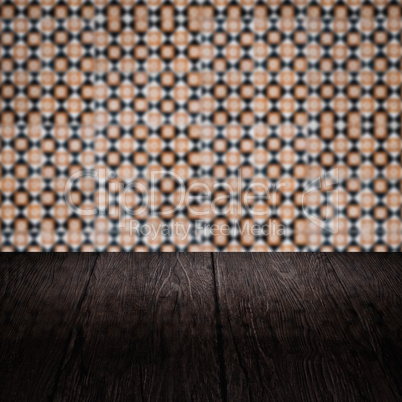 Wood table top and blur vintage ceramic tile pattern wall