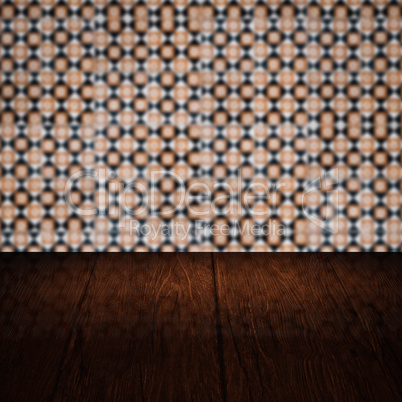 Wood table top and blur vintage ceramic tile pattern wall