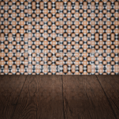 Wood table top and blur vintage ceramic tile pattern wall